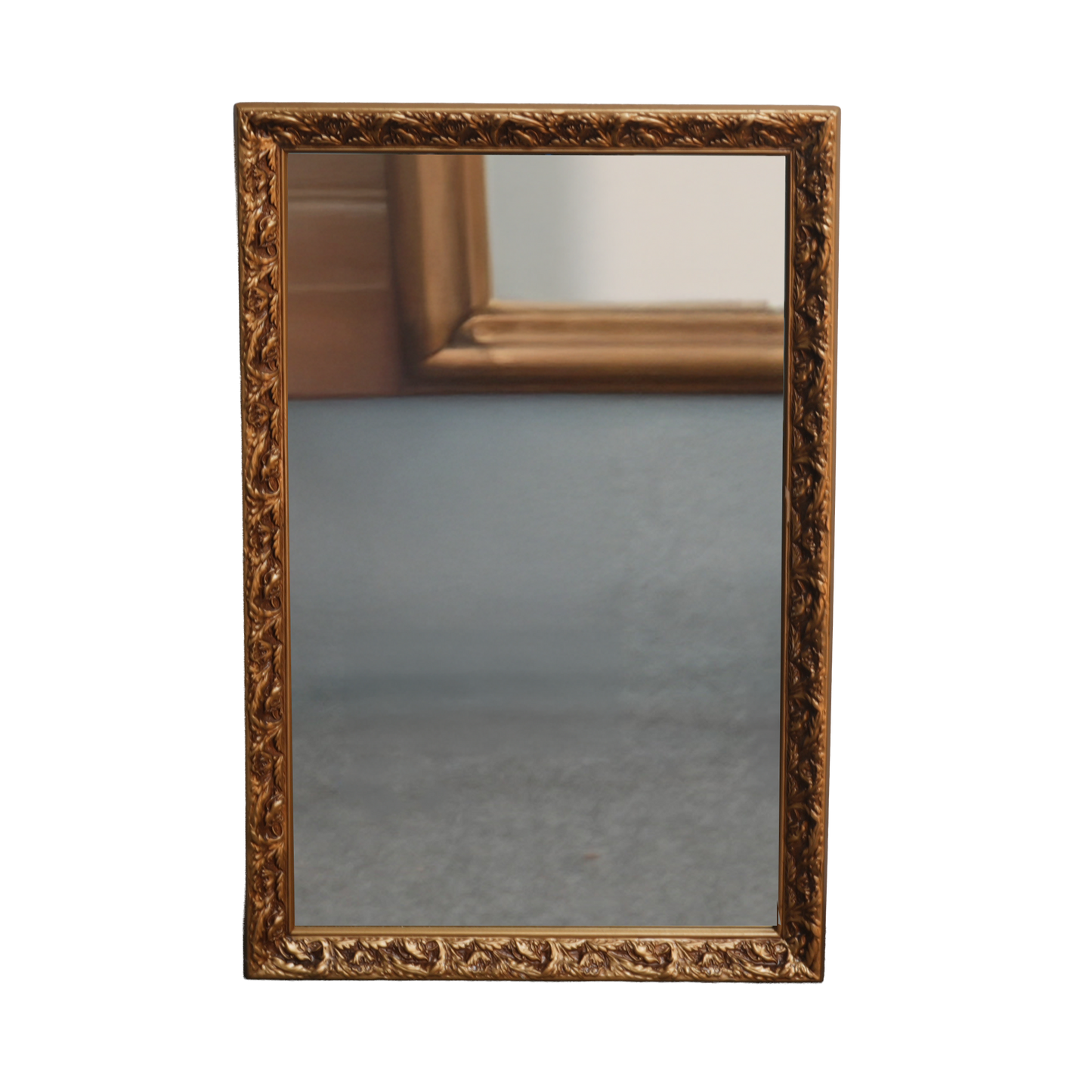 Decorative gold-framed mirror on a white background