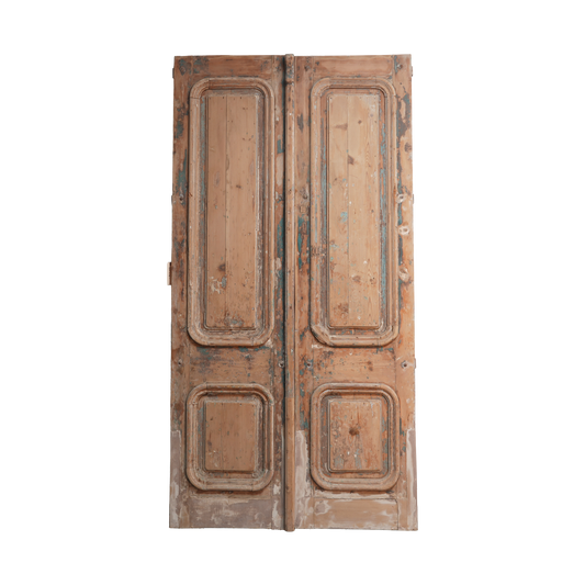 Pair of vintage wooden doors with intricate carvings on a white background