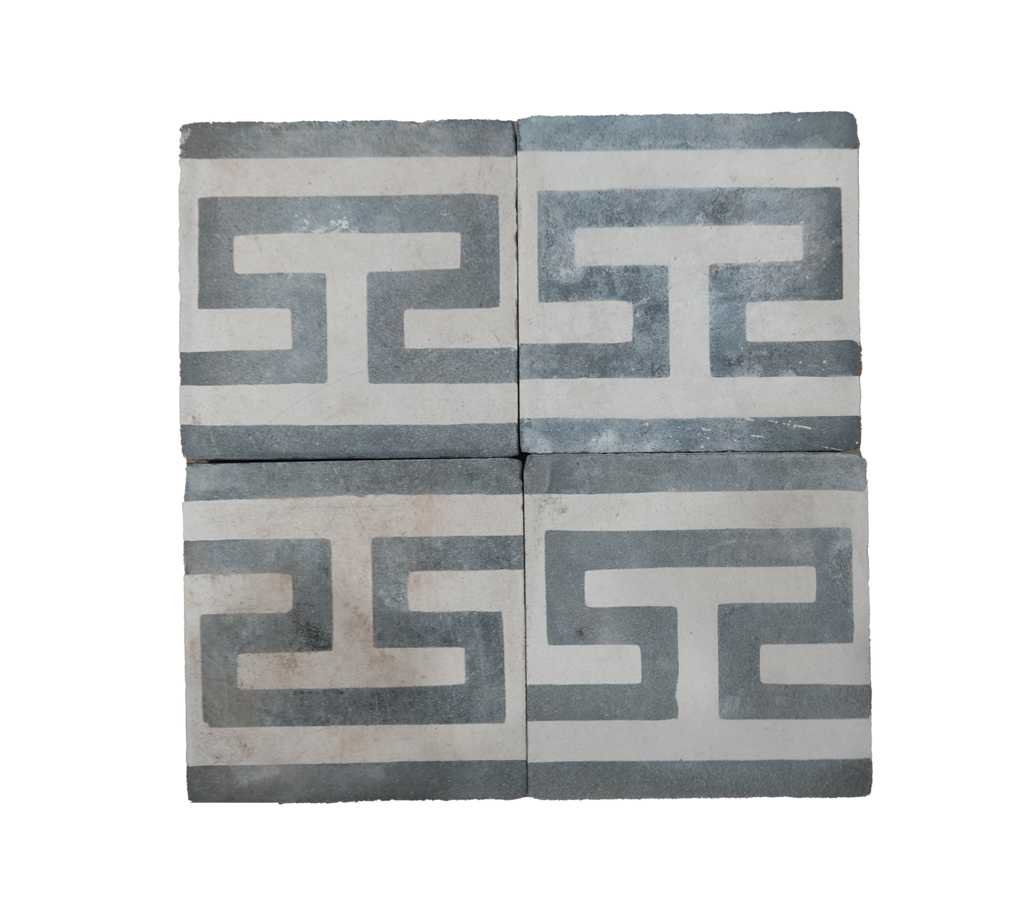 Two decorative tiles with Greek key pattern on a white background