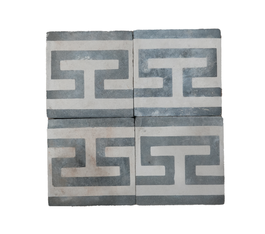 Two decorative tiles with Greek key pattern on a white background