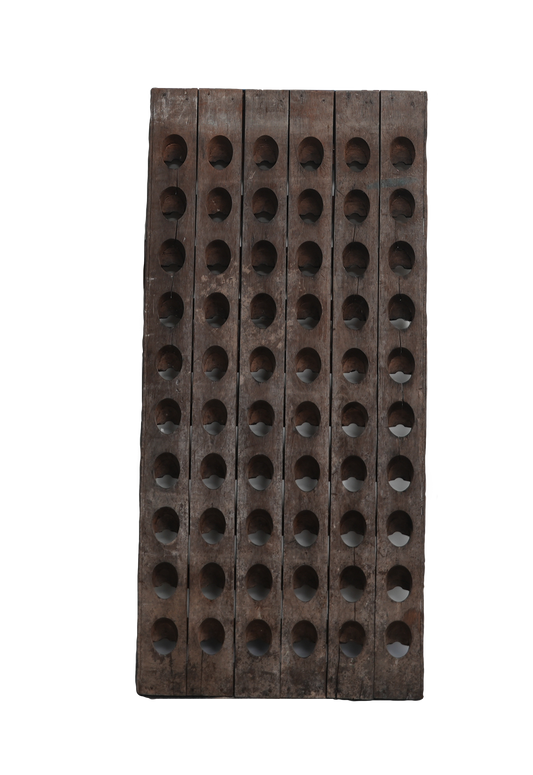 Wooden wine rack with multiple holes on a white background